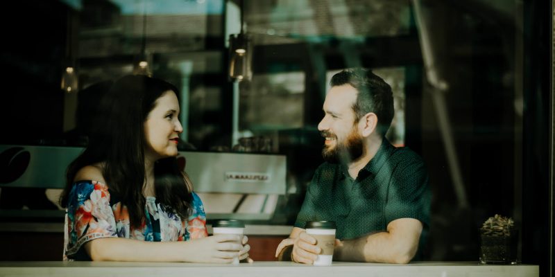 Man and woman talking at a coffee shop